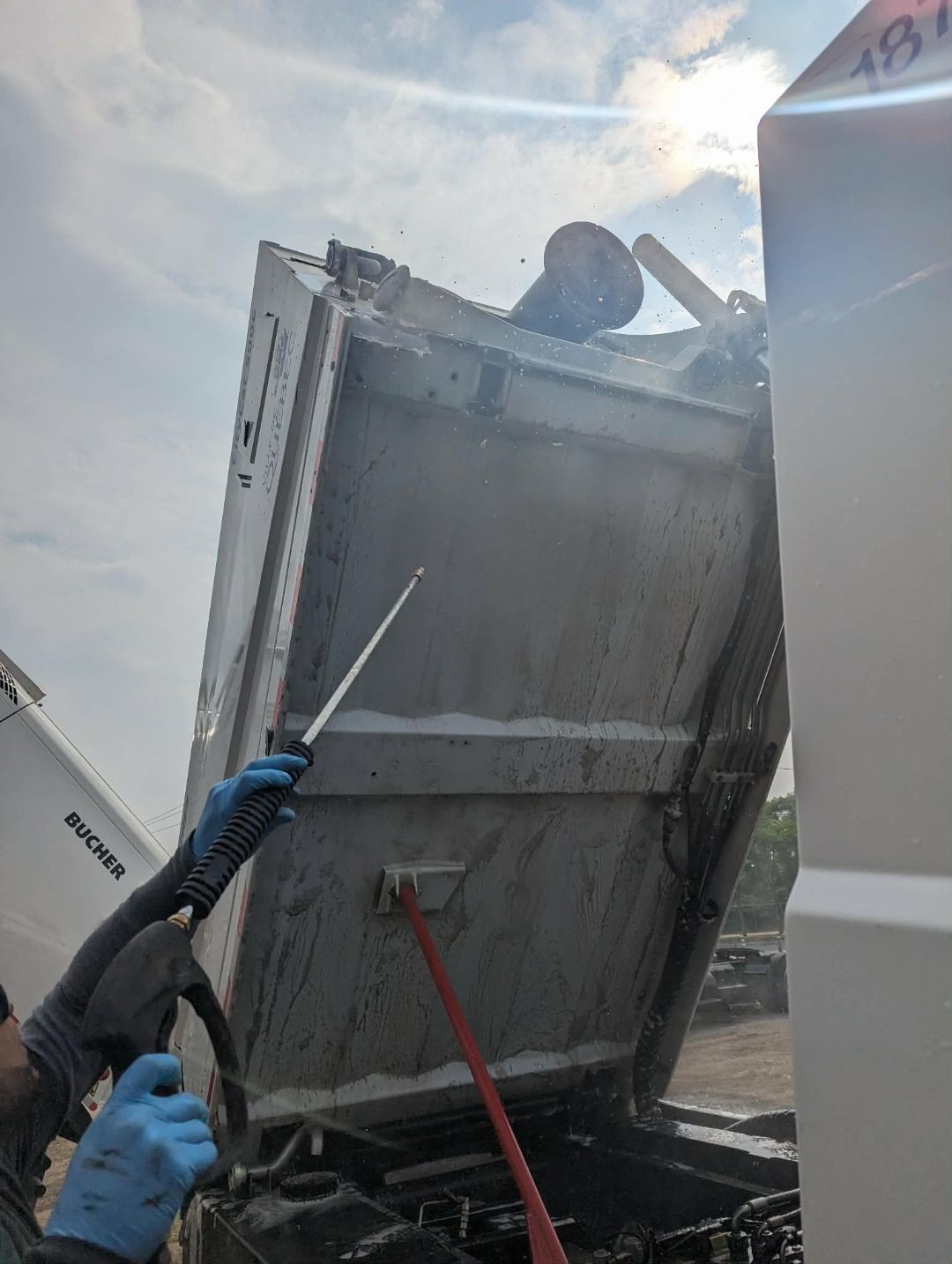Kabrani technician power washing the rear dump body