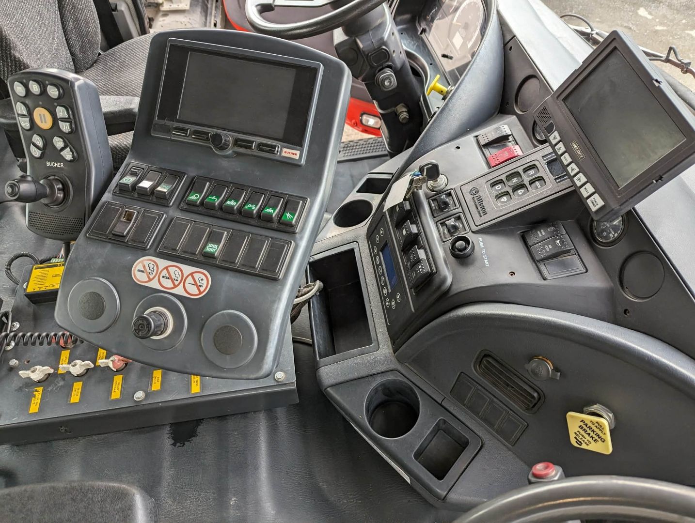 Bucher CityCat control console — heavy grime before clean