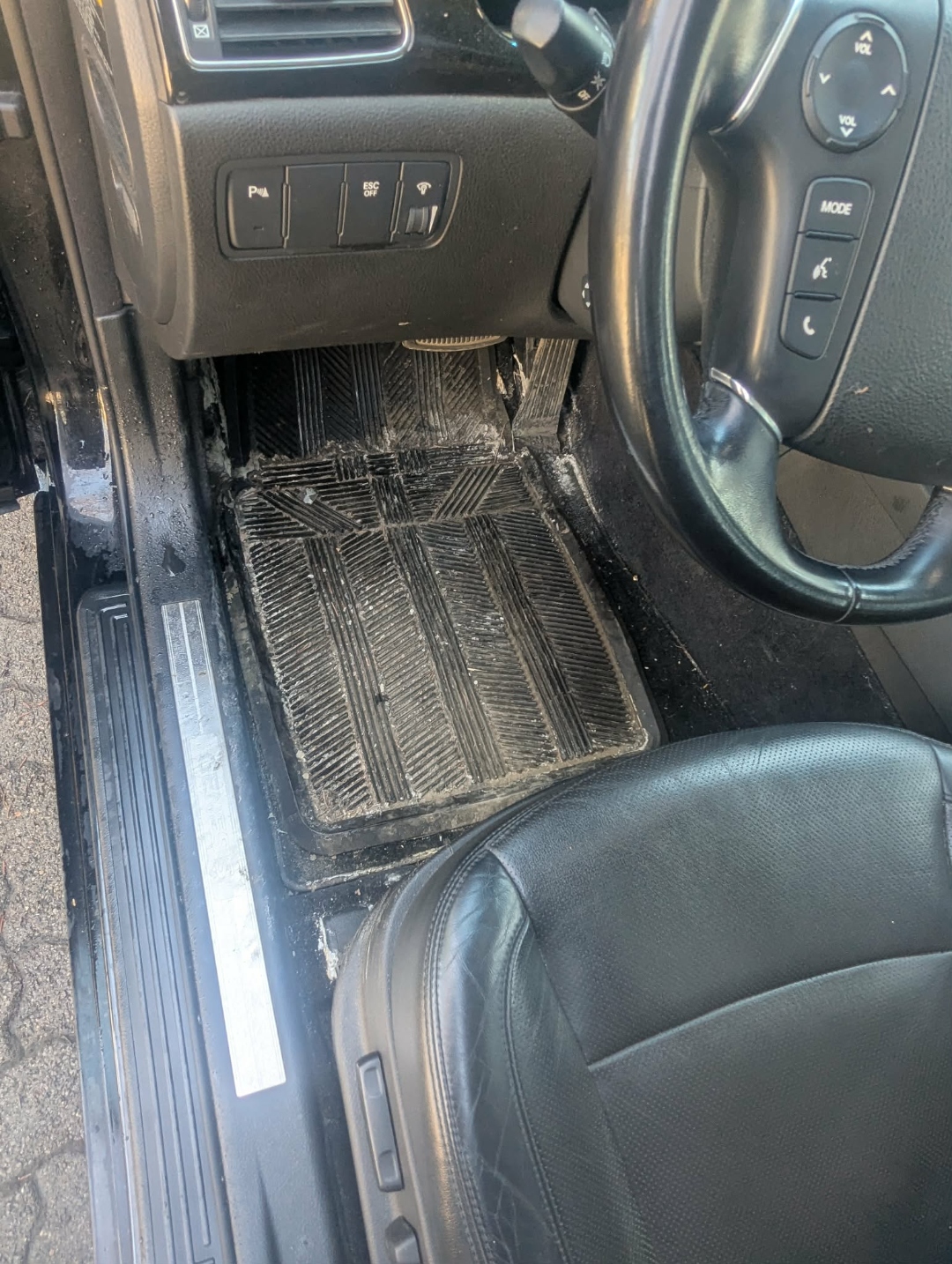 Hyundai Genesis — driver side floor mat heavily dirty with salt before interior detail