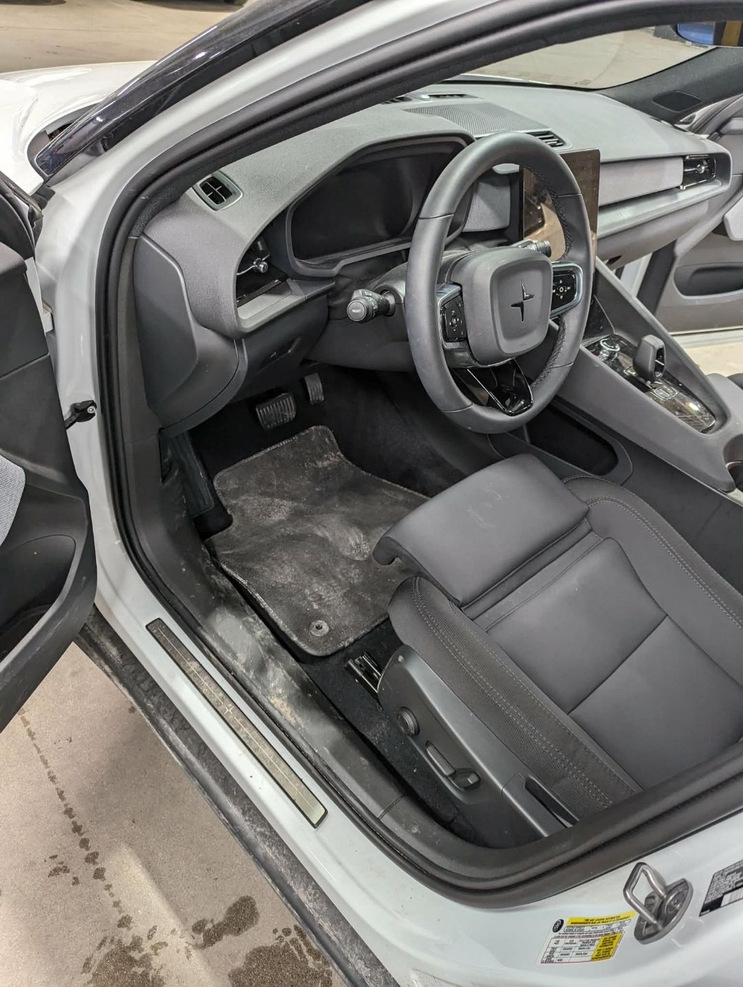 Polestar 2 White — driver side heavily soiled before interior detail