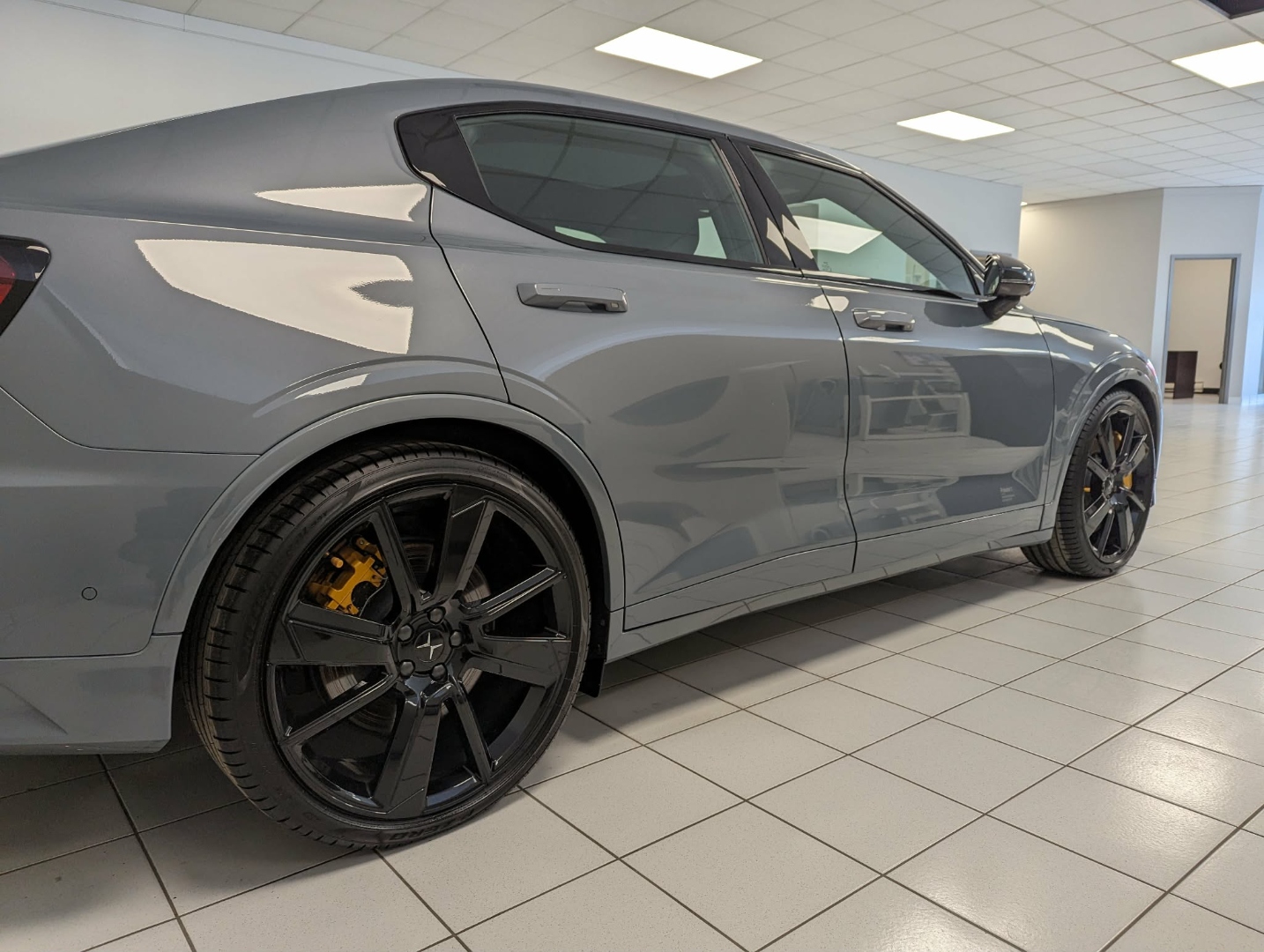 Polestar 2 Grey — side profile on dealership floor after exterior detail
