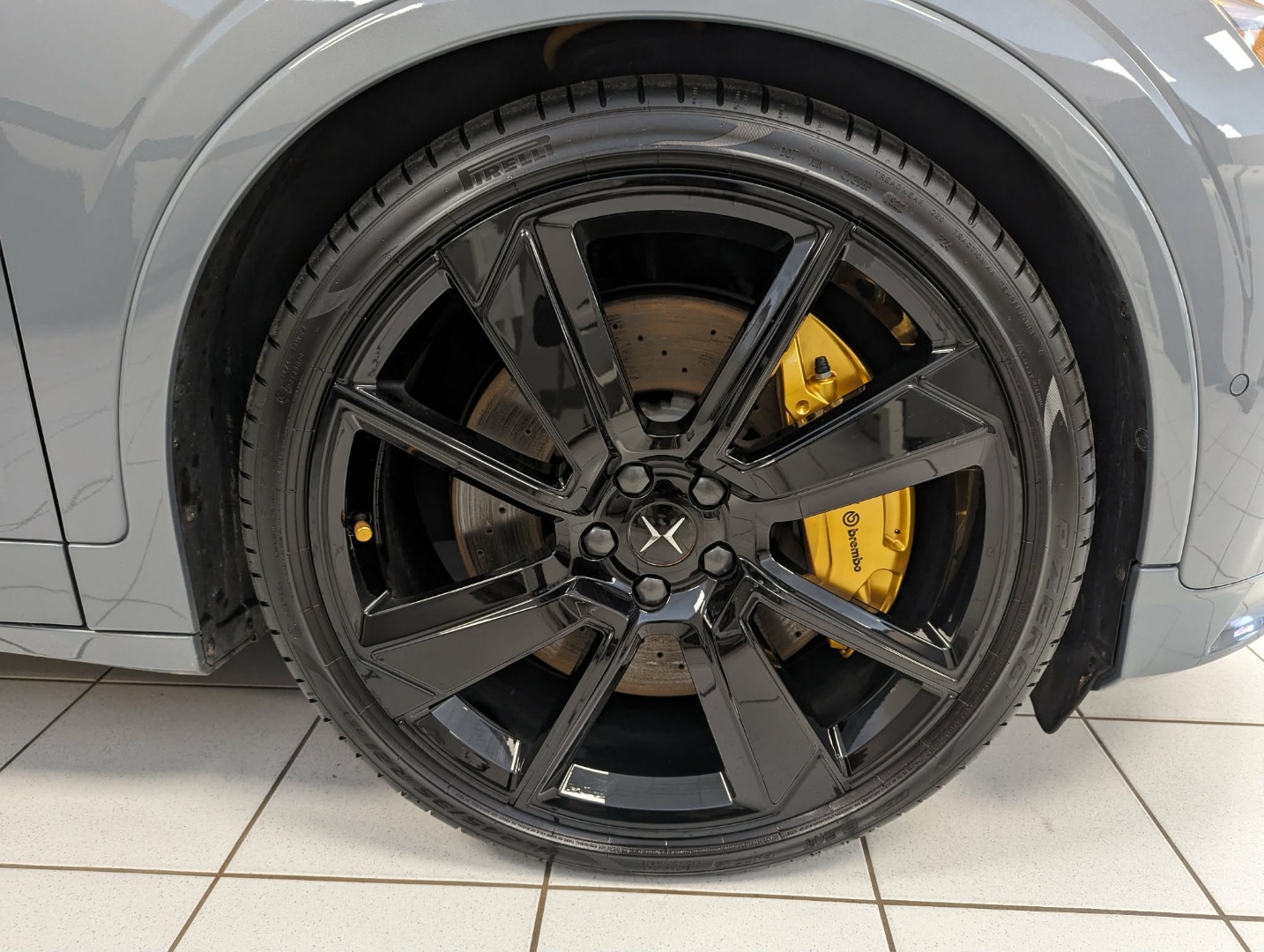 Polestar 2 Grey — wheel closeup with Brembo yellow caliper after exterior detail