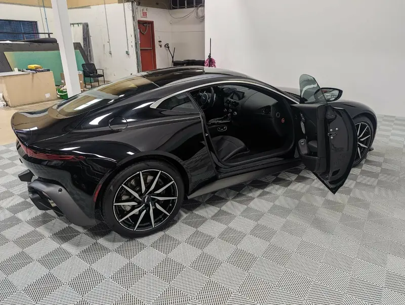 Aston Martin Vantage — rear 3/4 with door open after full detail