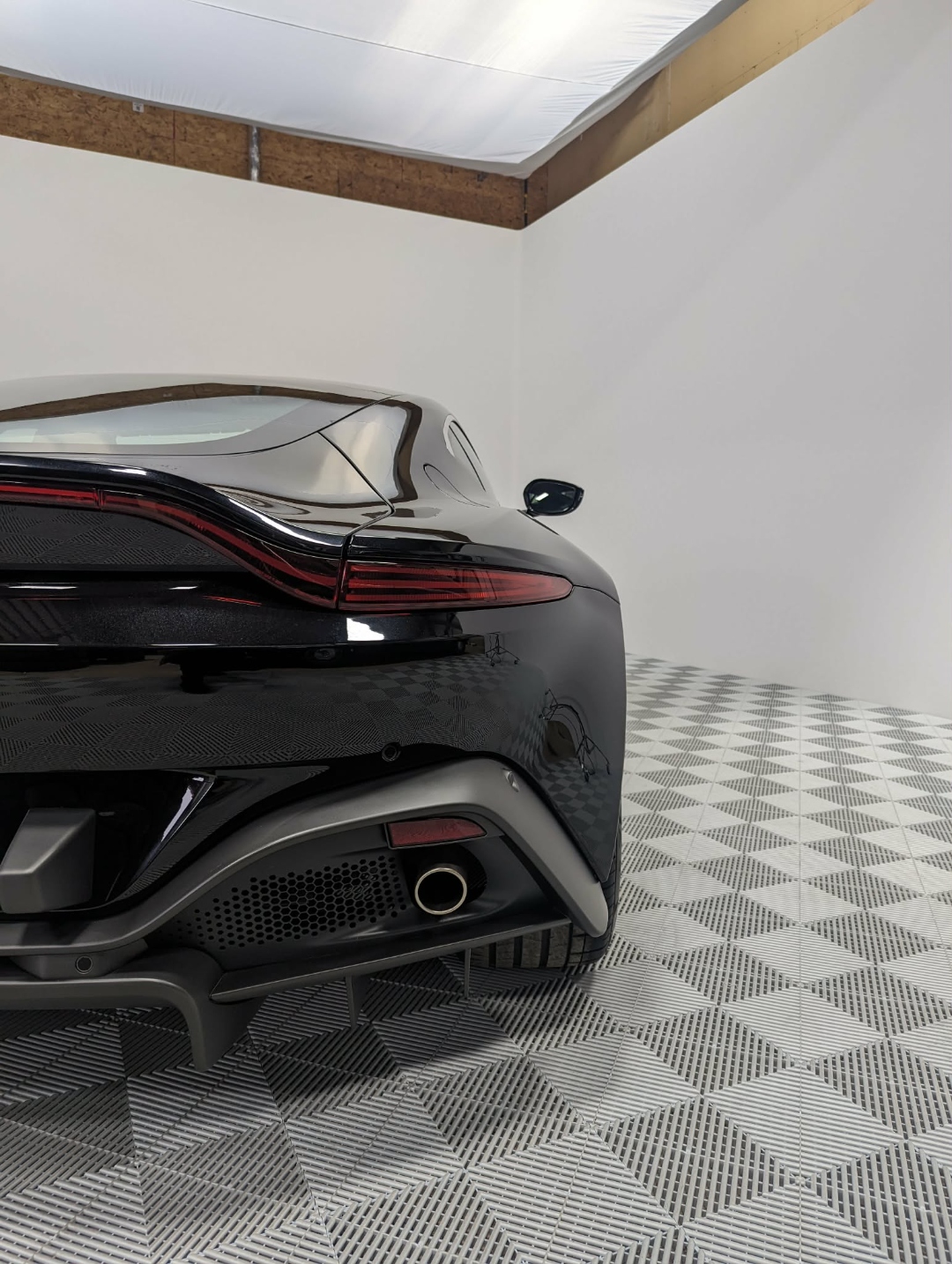 Aston Martin Vantage — rear 3/4 studio shot after full detail