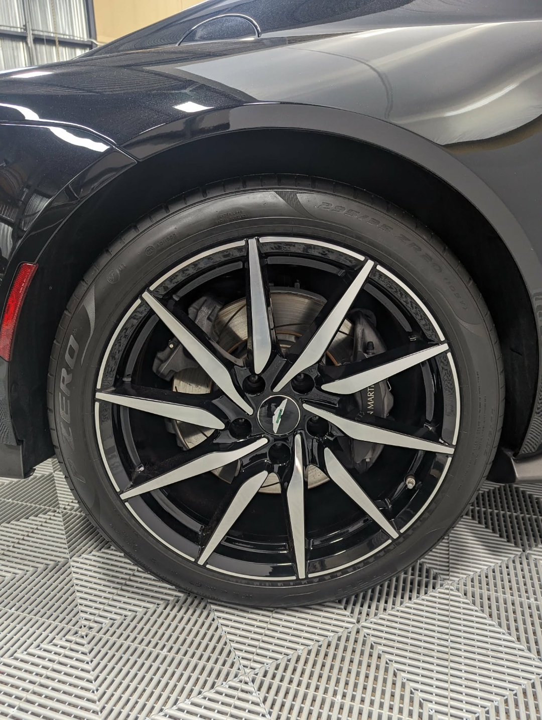 Aston Martin Vantage — wheel closeup with Aston Martin logo after full detail